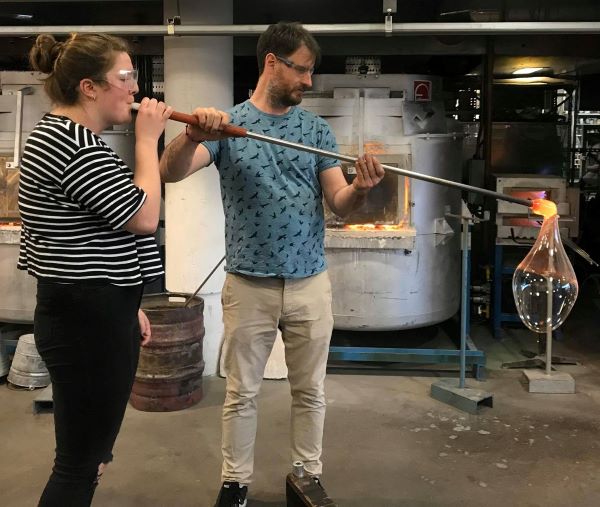 Master's student Amy Farrer blows glass at the National Glass Centre in Sunderland